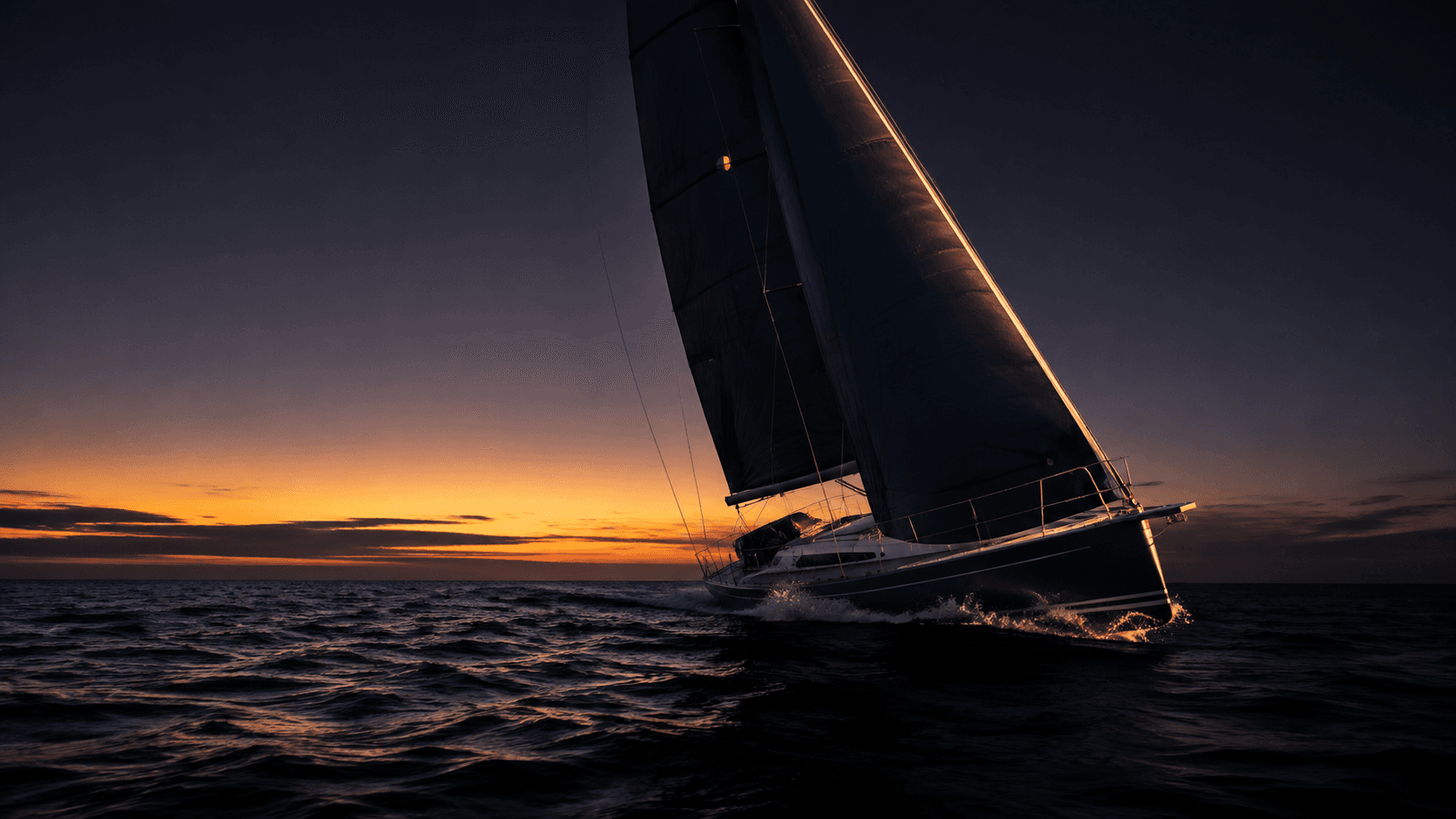 A modern sailing yacht navigating open water at blue hour